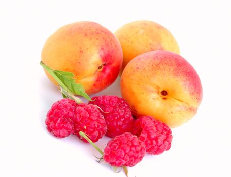 close-up of raspberry with leaves and apricots