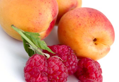 close-up of raspberry with leaves and apricots