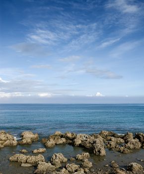 Coral reef rock coastline with blue sky.