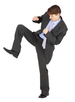 A young man kicks on a white background