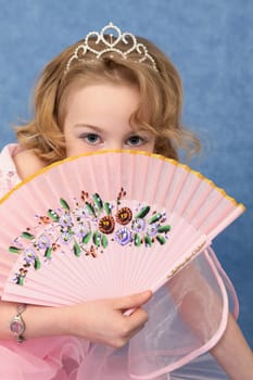 Girl coyly covered her face with pink glamorous fan