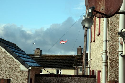 a helicopter on a life air sea rescue mission over an urban area in ireland