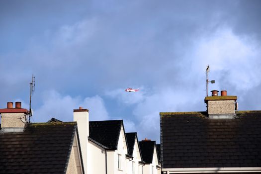 a helicopter on a life air sea rescue mission over an urban area in ireland