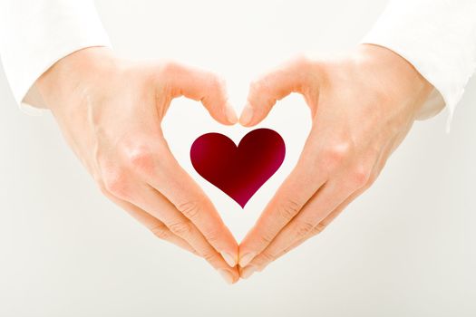 A small red heart in men's hands