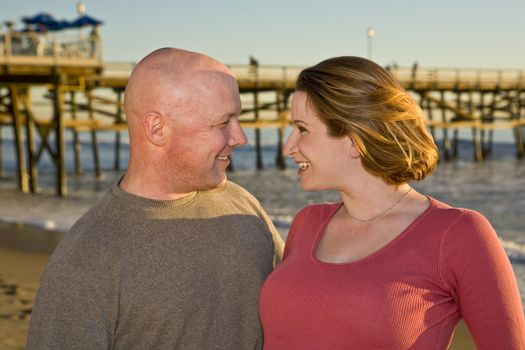 Couple in love at the beach looking into each others eyes
