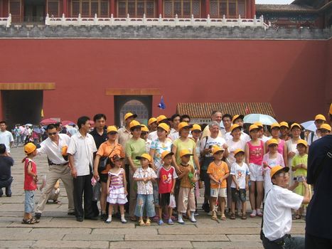 Chinese tourists photography group portrait in the Forbidden city in Beijing