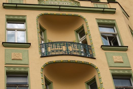 Architectural detail of the building in style of the art-nouveau with windows and balcony.