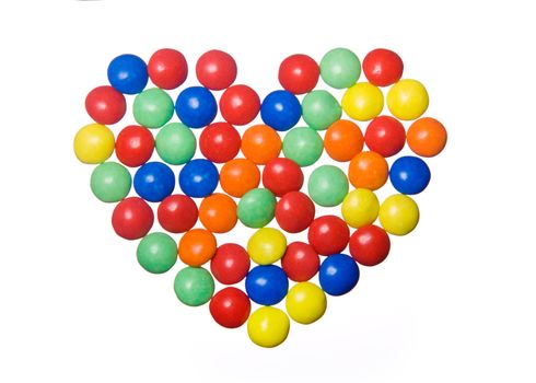 Colorful candies arranged in a heart shape