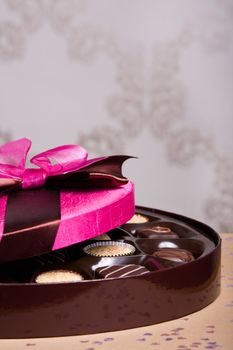 Luxury chocolates with a pink satin lid