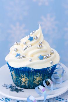 Cupcake with a winter theme against a snowflake background