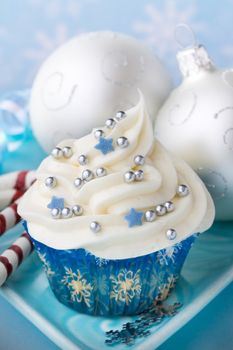 Cupcake with a winter theme and Christmas baubles