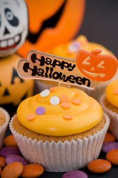 Happy halloween cupcake decorated with orange frosting