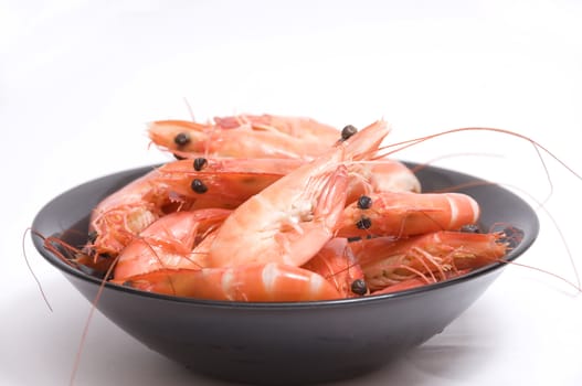 close up on a bowl of raw and fresh shrimps, isolated on white