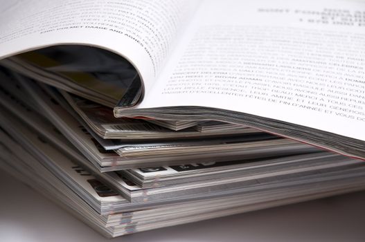 close-up on a stack of magazines, isolated on white