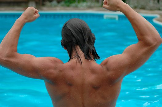 A muscular swimmer shows off his powerful shoulders.