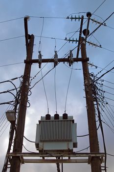 High voltage electricity transformer high on poles in England