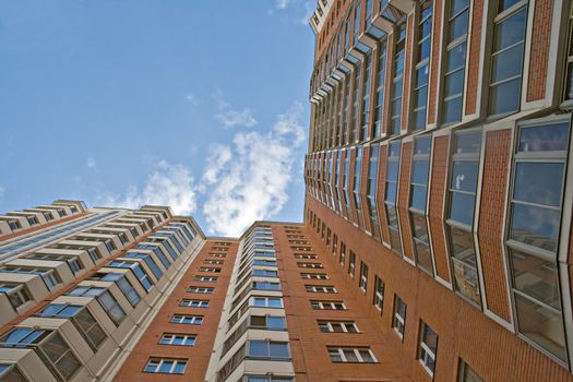 A residential multistory house and sky, view from below