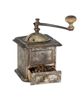 Antique coffee grinder filled with coffee beans isolated on white background