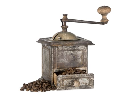 Antique coffee grinder filled with coffee beans isolated on white background