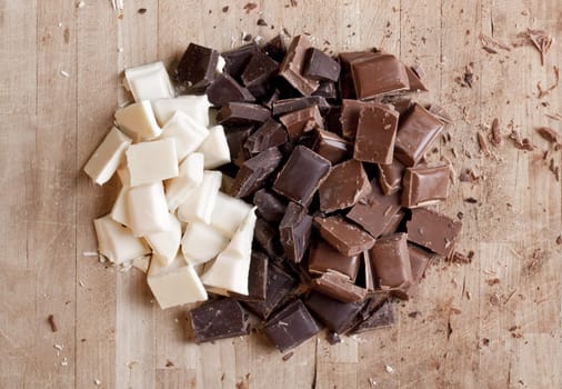 Many flavors of chocolate chopped up ready for use