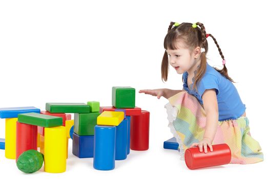 Girl playing with color toys on white background
