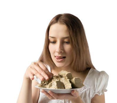 a girl eating tasty halavah. Isolated on white