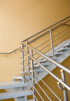 stairway enclosure with metallic stair railing within building