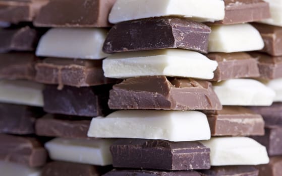 Many flavors of chocolate stacked up