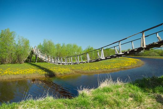 narrow rope pedestrian bridge over water