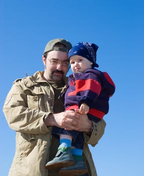 Family under blue sky.father and son