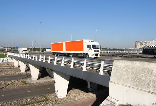 Highway overpass with crossing truck