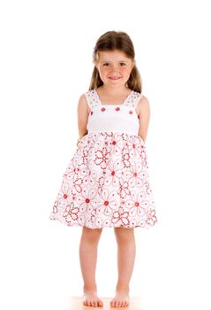 Little innocent girl on isolated background with hands behind her back