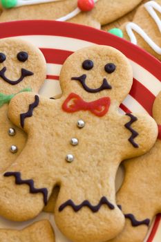 Gingerbread men arranged on a red and white plate