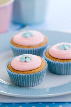 Cupcakes decorated with blue sugar flowers