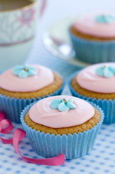 Cupcakes decorated with blue sugar flowers