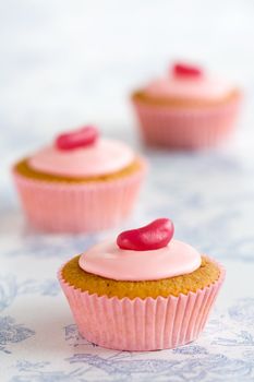 Three pink cupcakes decorated with jellybeans