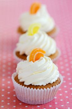 Orange and lemon cupcakes on a polka dot tablecloth