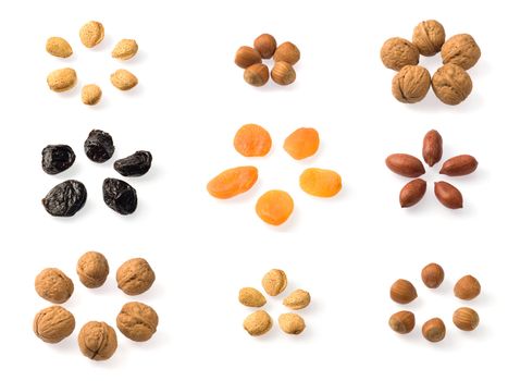 Whole dried fruits collection over white. Includes almonds, hazelnuts, pecans, walnuts, prunes and dried apricots. Includes almonds, hazelnuts, pecans, walnuts, prunes and dried apricots.