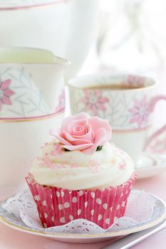 Rose cupcake on a china plate