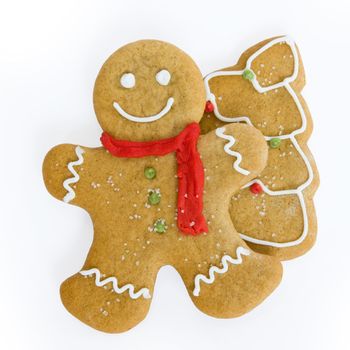 Smiling gingerbread man and christmas tree cookie