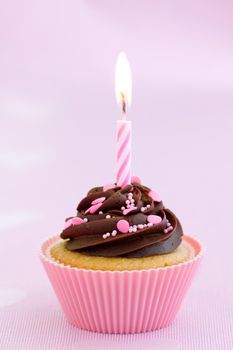 Chocolate cupcake decorated with a single candle