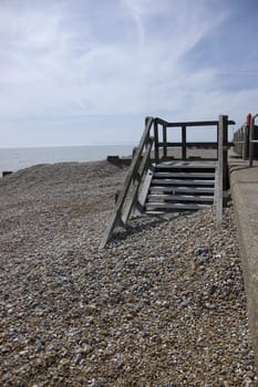 A pebble beach with wooden steps