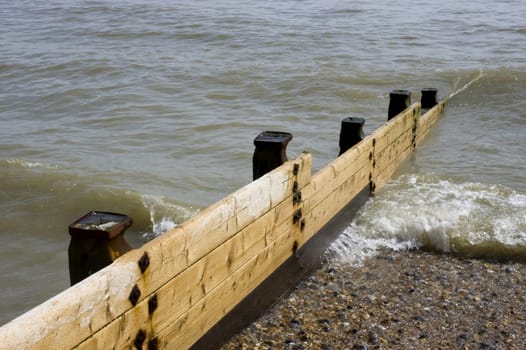 Groyne leading into the sea on a cold day