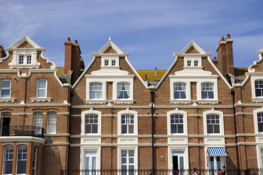 A row of victorian townhouses with a blue sky