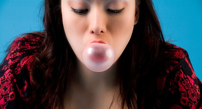 Young girl with some bubble-gum in her mouth