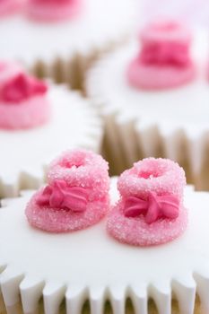 Cupcakes decorated with tiny pink sugar booties