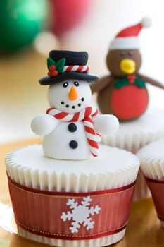 Christmas cupcakes decorated with a snowman and robin