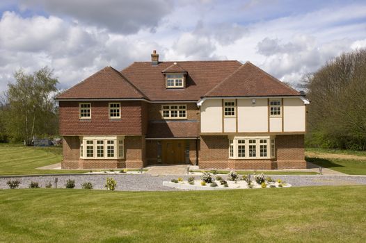 A big detached home with a cloudy sky