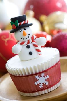 Christmas cupcake decorated with a cheerful snowman