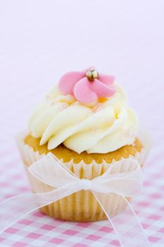 Cupcake decorated with a pink sugar flower